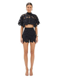 Paula Fashion House black high-waist shorts with floral cutwork and scalloped hem, worn by a model.