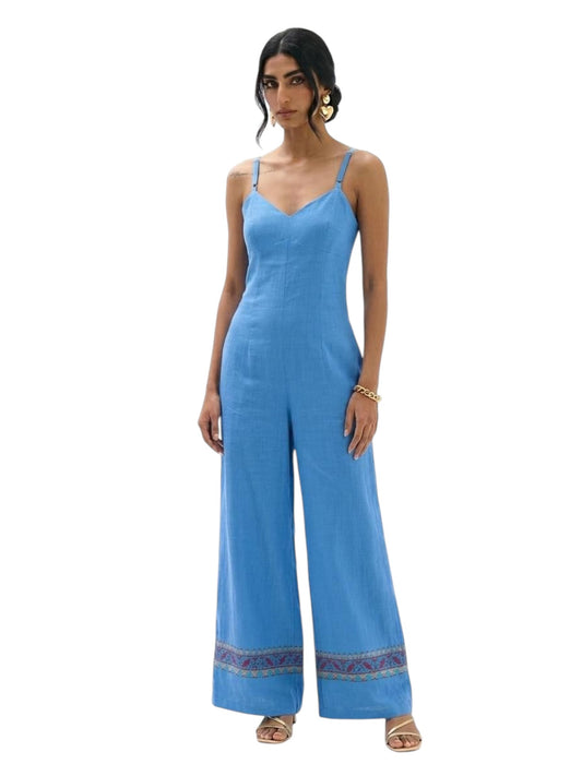Paula Fashion House sky blue linen wide-leg jumpsuit with sweetheart neckline, adjustable straps, fitted bodice, and embroidered hem trim.