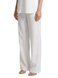 Paula Fashion House white wide-leg linen trousers with a high waist and relaxed fit. Model wears them with a matching halter top.